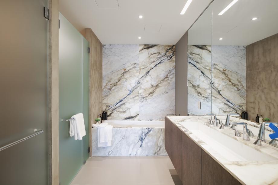 Primary baths with roman tub, clad in striking Calacatta Paonazzo marble