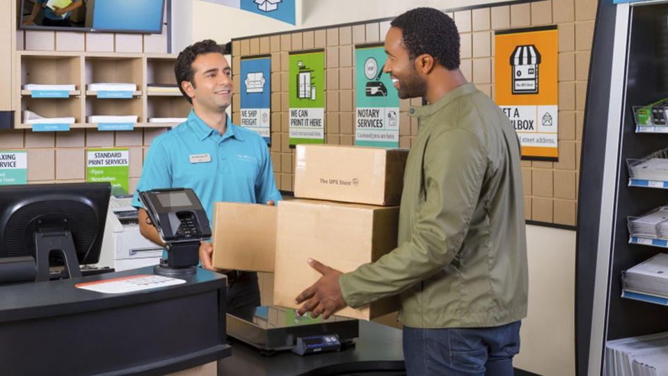 Customer dropping off packages to be shipped at front counter