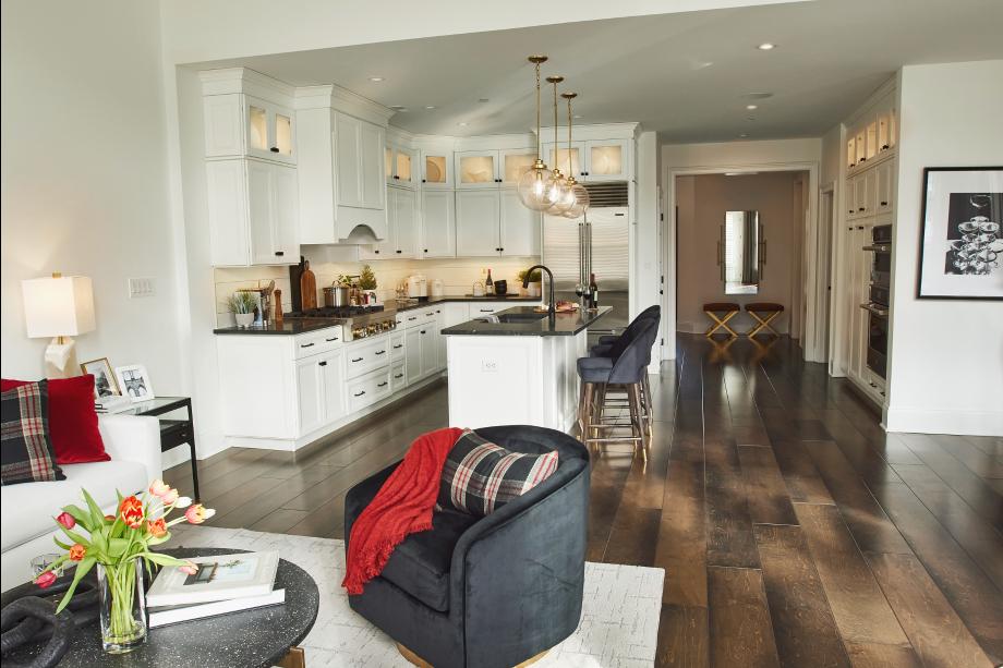 A large center island in the kitchen overlooks the living area