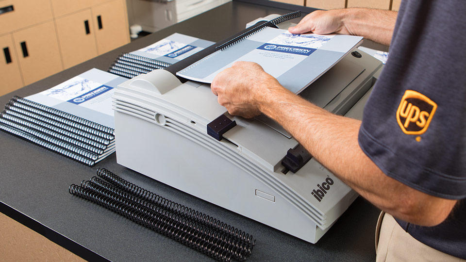 store associate binding a presentation for customer