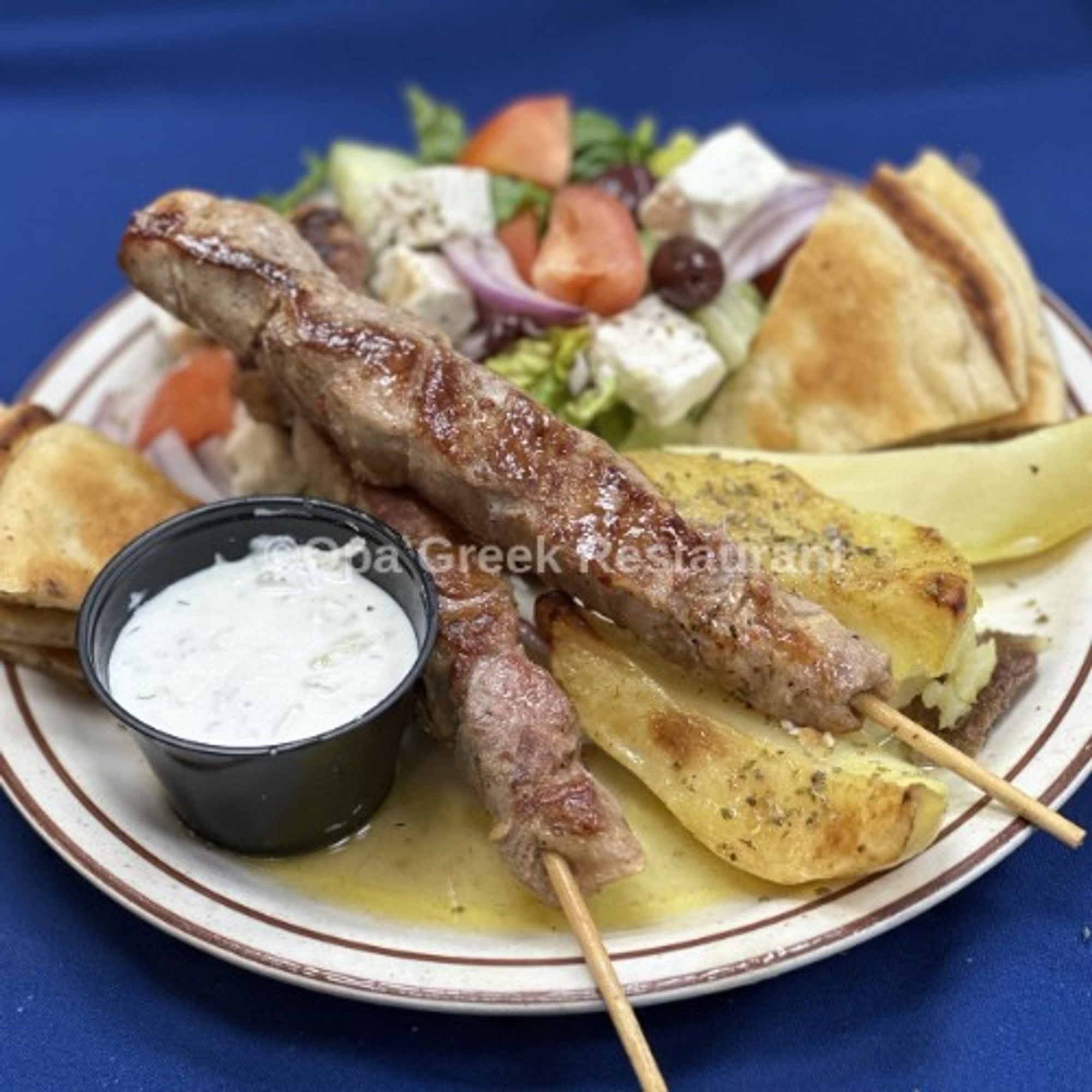 Pork Souvlaki (2 Skewers) Platter Greek Salad, Pita Bread, Tzatziki Sauce, Choice Of Lemon Potato...
