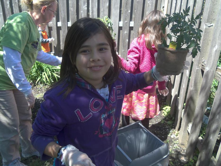 School age students plant flowers together, creating memories that will last a life time.