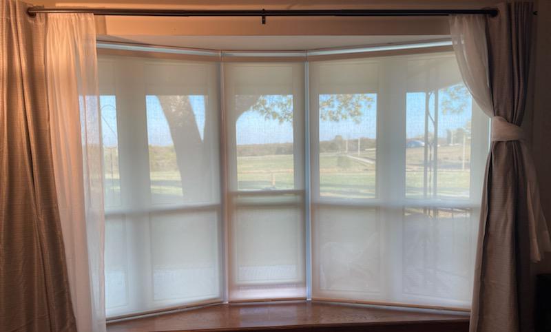 Welcome to the home of Mary and Don in Venita! They recently contracted us to create something special for this beautiful bay window. We installed Panel Tracks and Roller Shades-perfect to filter light but keep the view!  BudgetBlindsOwasso  RollerShades  PanelTracks  VenitaOK  FreeConsultation  Win