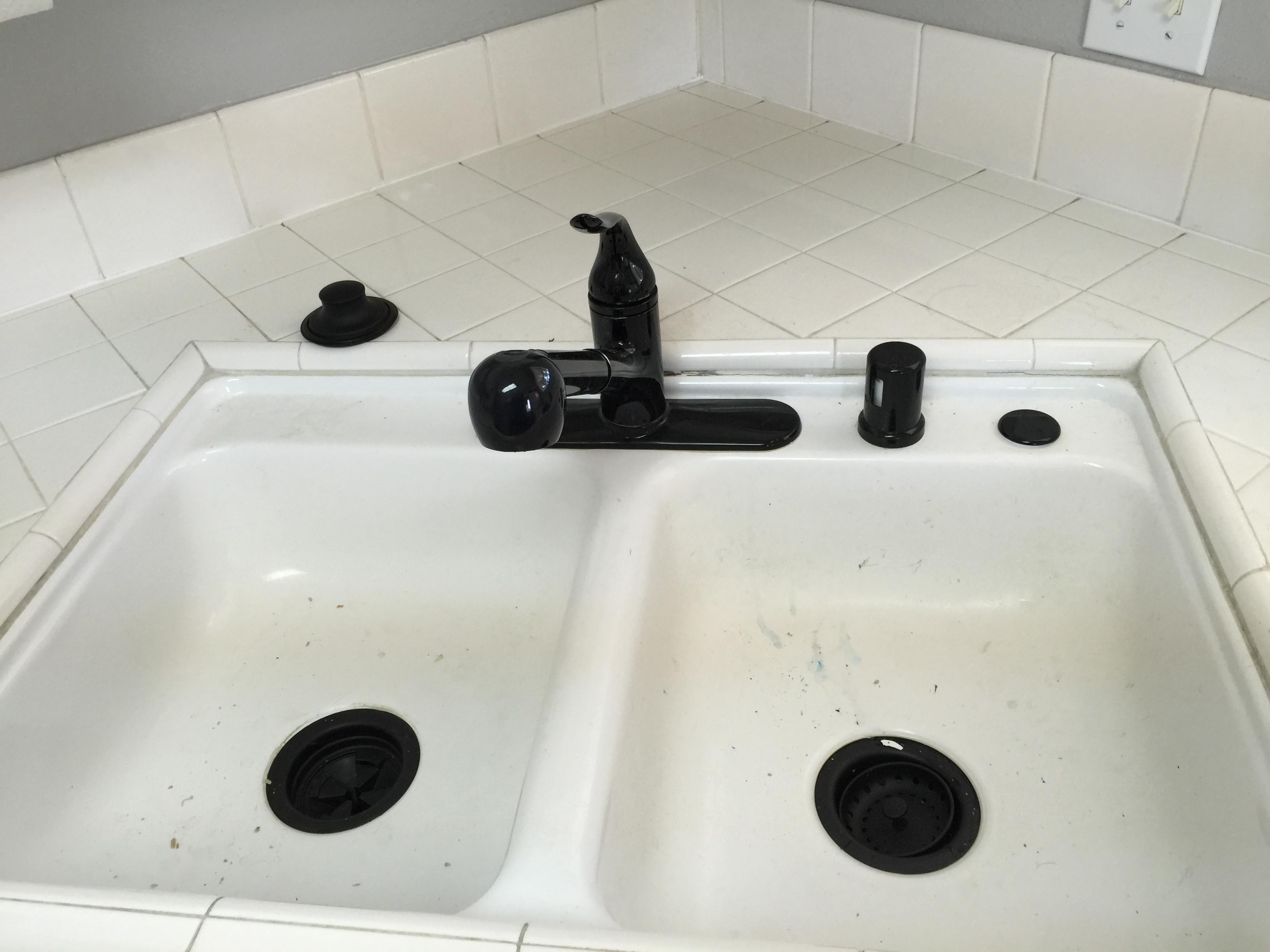 Install Black drain baskets along with kitchen faucet and air gap