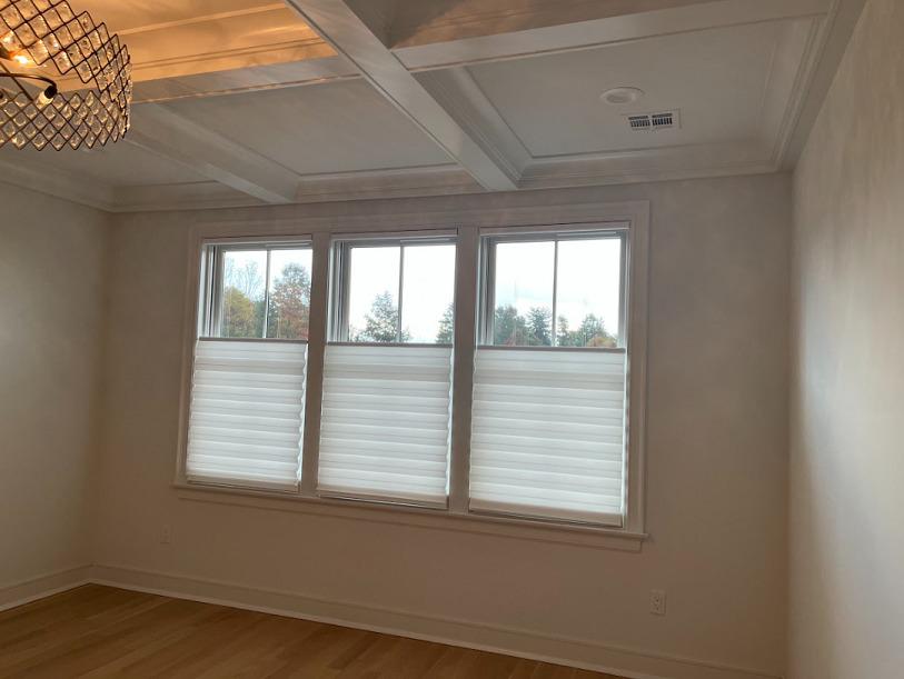 Want window coverings that have a sharp, clean look? Check out the Hunter Douglas Solera Shades in this home! Perfect for shade-and they don't take away from the beautiful chandelier and woodwork!