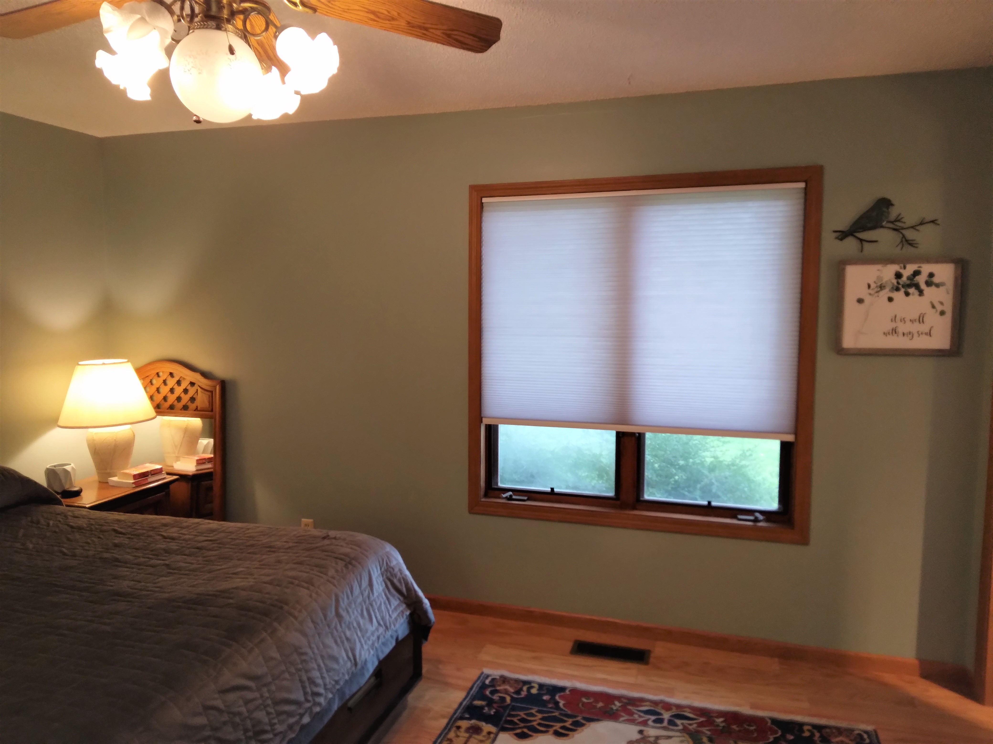 Grey light-filtering cellular shades in Springfield Illinois bedroom.  BudgetBlinds  WindowCoverings  Shades  CellularShades  SpringfieldIllinois