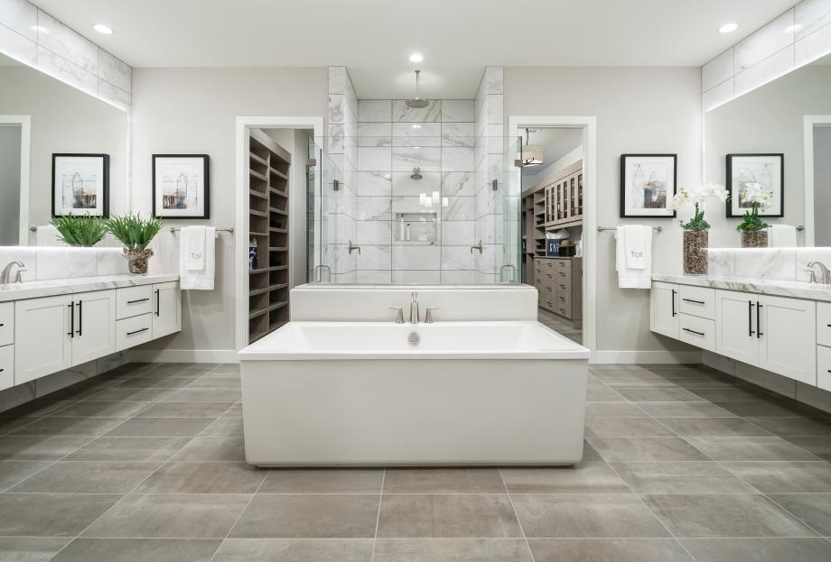 Lavish primary bathrooms with large walk-in showers, and freestanding soaking tubs