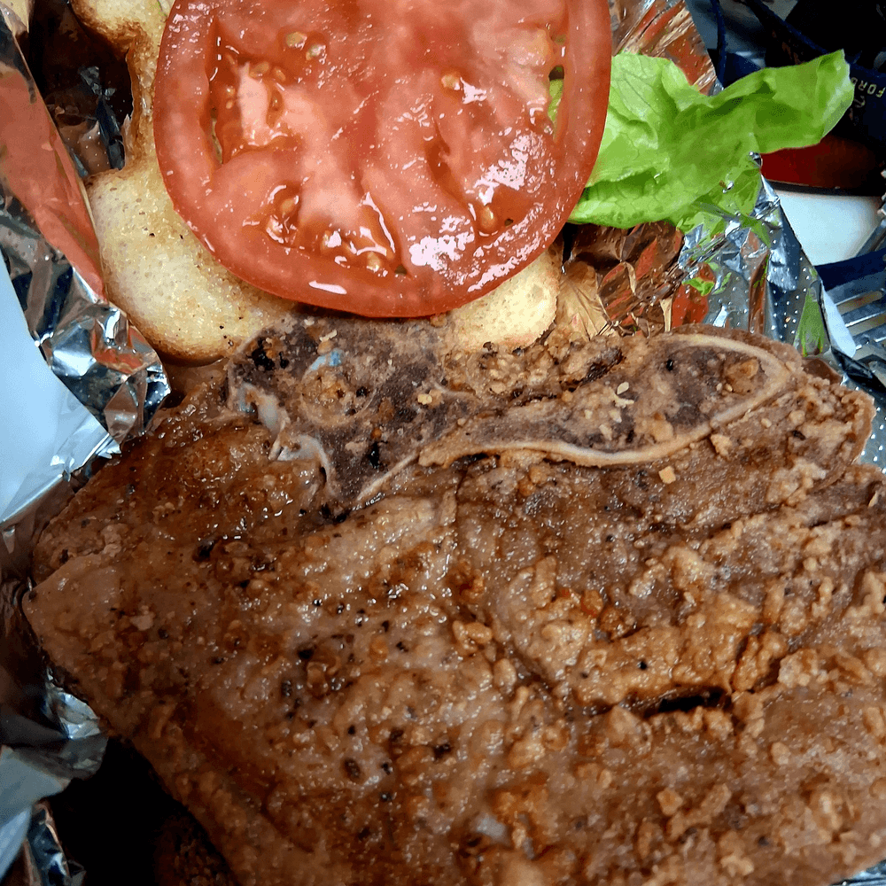 Pork chops sandwich with mayo, lettuce, tomato