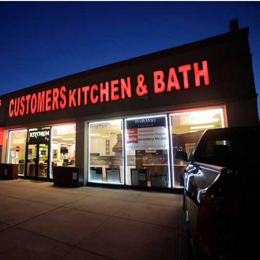 Custom-ers Kitchen &amp; Bath Cabinets Logo