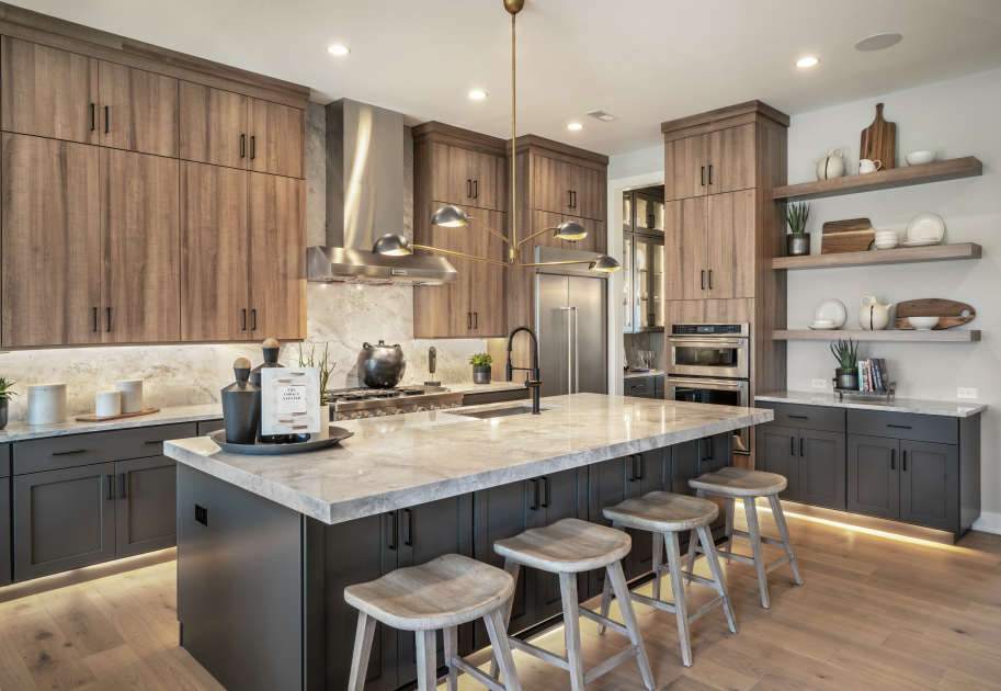 Gourmet kitchen includes large center island, ample counter and cabinet space, and pantry storage