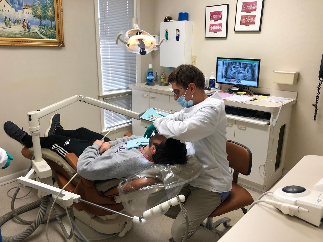 Dr. Dan Meader with patient in dentist chair complete dental care a dentist in columbia sc
