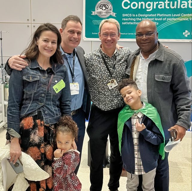 Family and doctors posting for camera