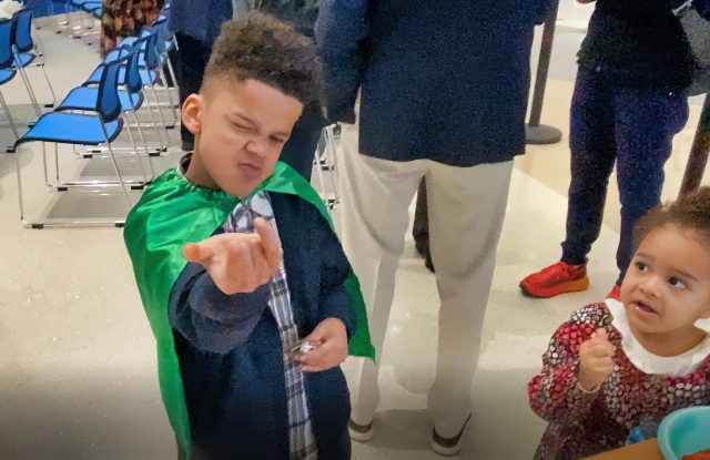 Boy shows Spider-Man moves.