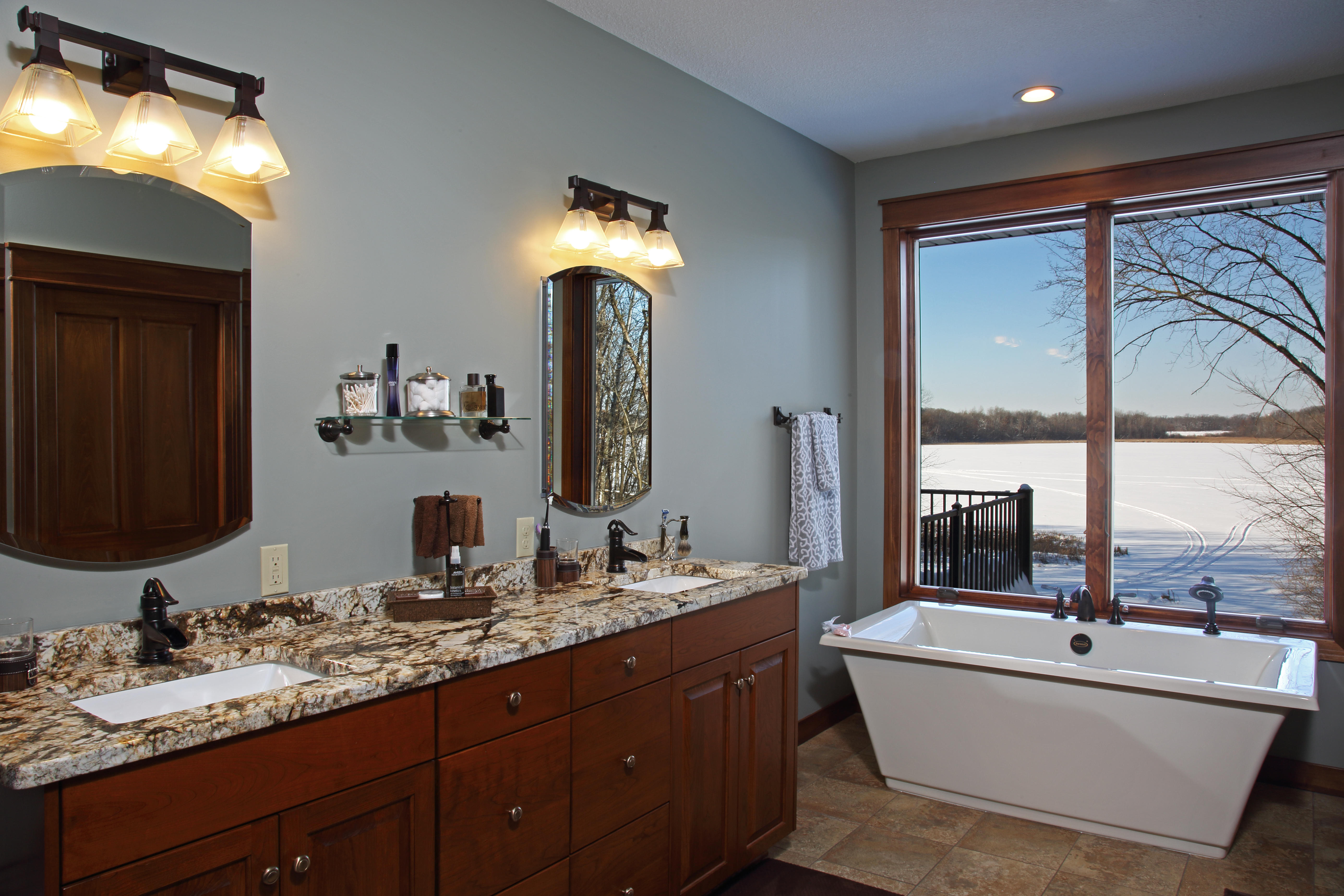 This luxurious master bath has spacious duel sinks and an above ground tub overlooking the bluffs.