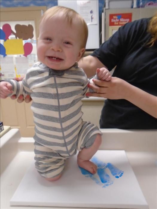 Our babies engage in many different sensory activities throughout the day. Here is James enjoying getting his foot painted for a footprint art project.