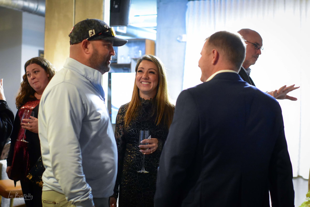 Brandy Garza with her husband and COR VP of Operations John Garza (right) and Shane Parker (left) at COR Bookkeeping &Consulting's grand re-opening.