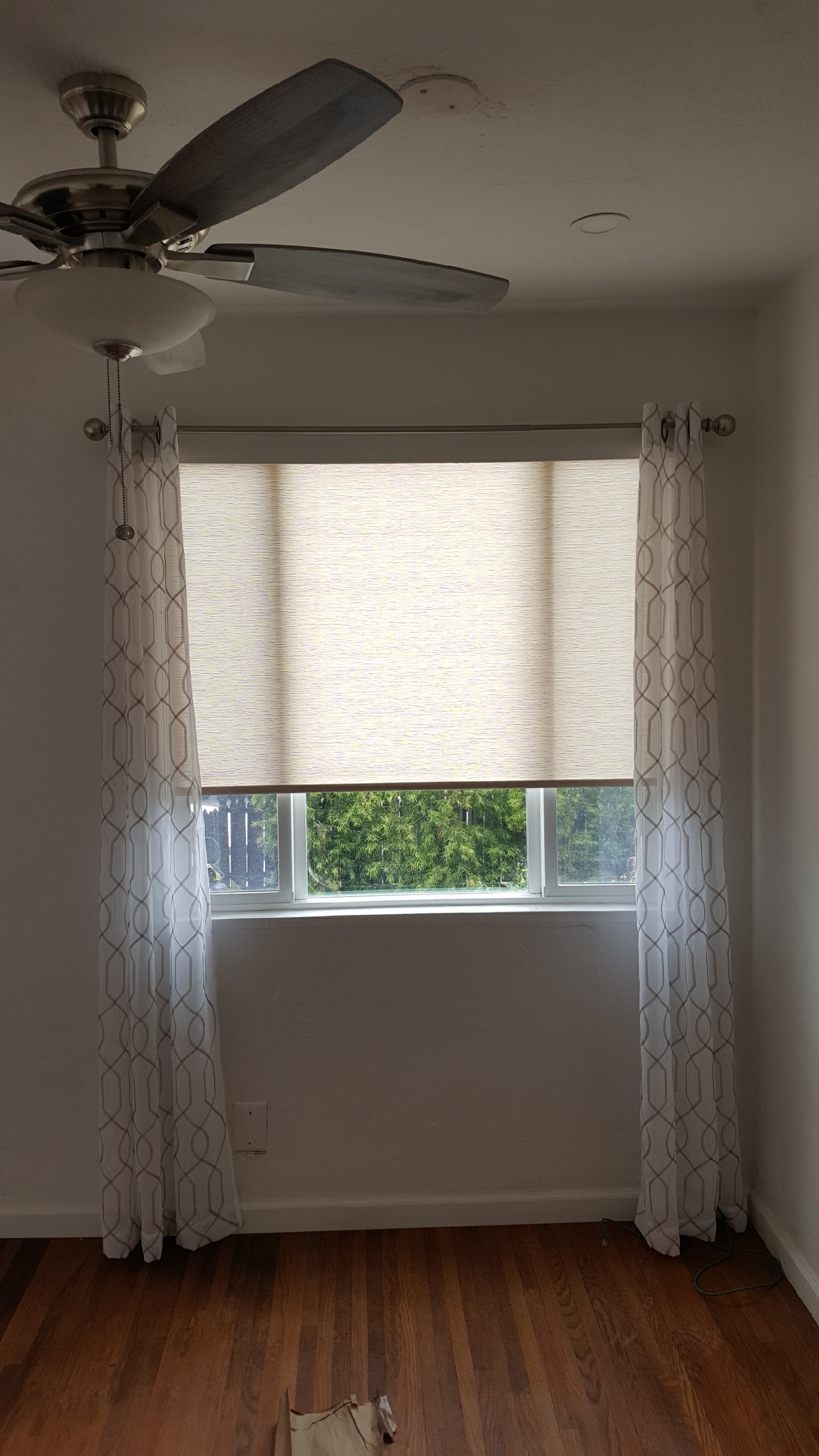 Roller Shades with Wood valance and customers own side panels in Clairemont.