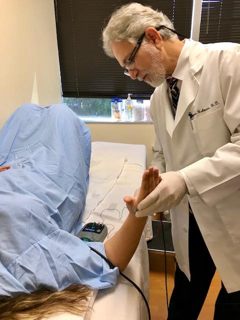 Dr. Kamran Hakimian performing a nerve conduction study on a patient at California Sports & Rehab to rule out any pinched or damaged nerves