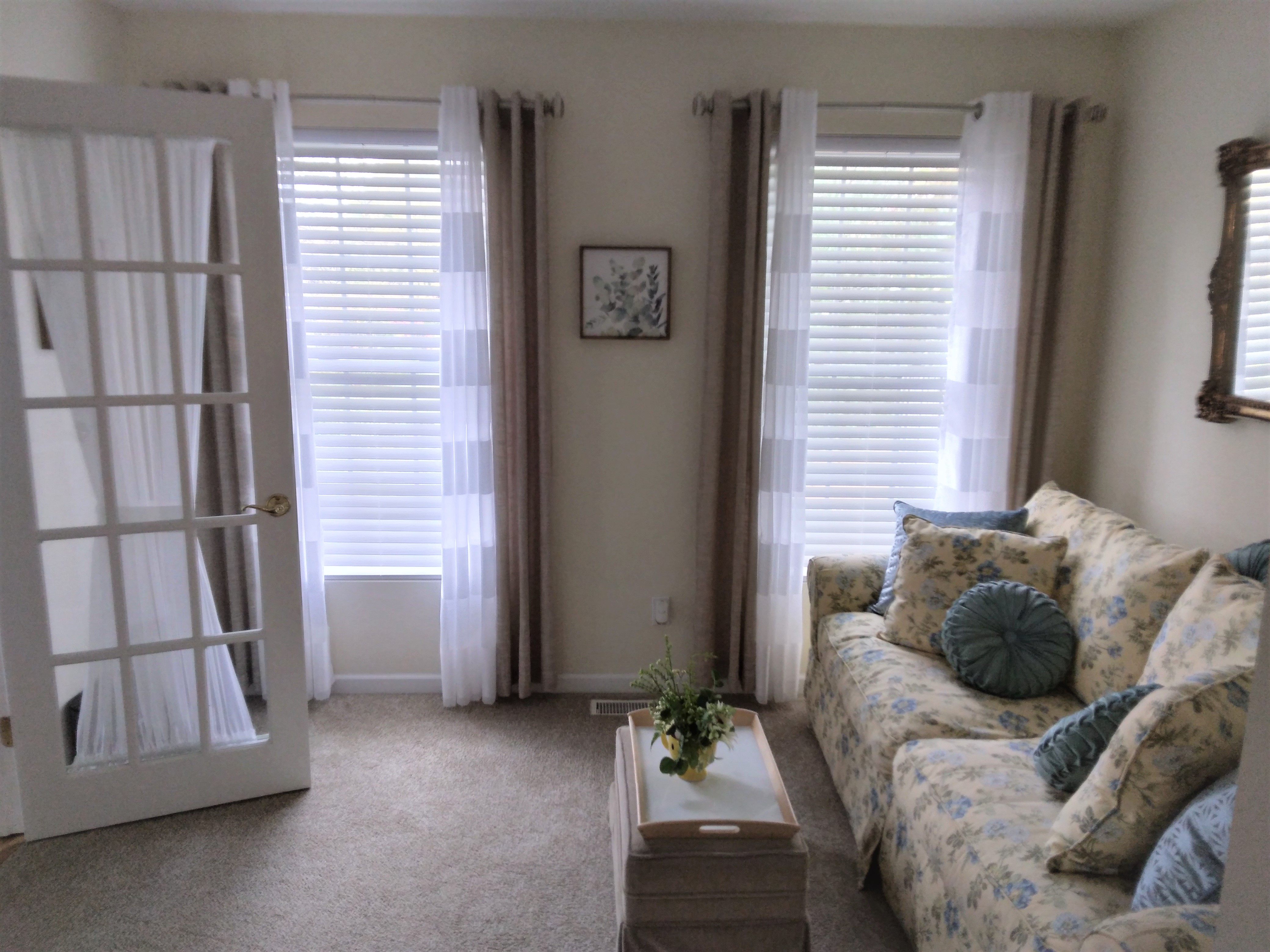 White, cordless faux wood blinds in Springfield Illinois living room.  BudgetBlinds  WindowCoverings  Blinds  SpringfieldIllinois