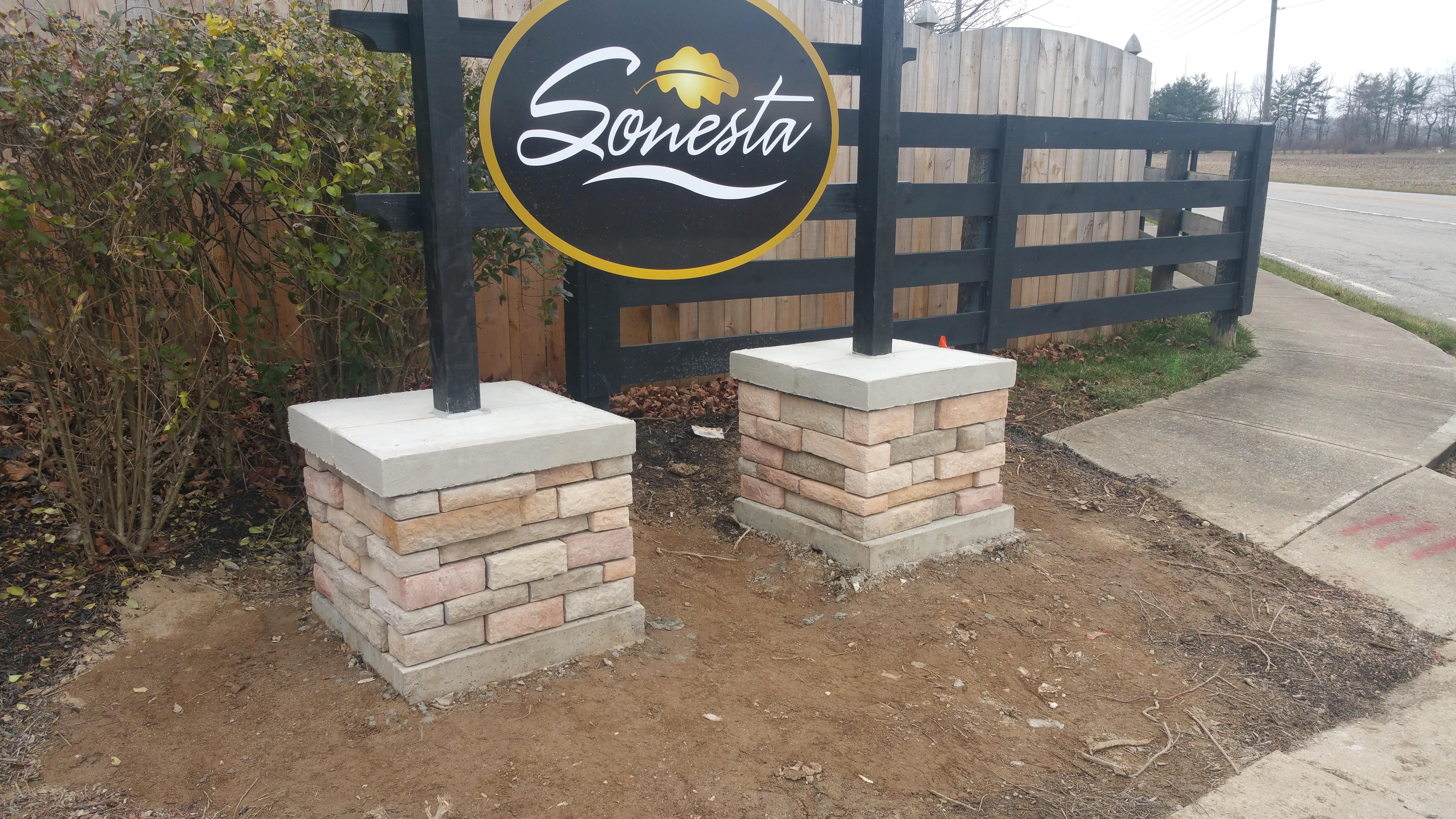 We installed the foundations, stone piers and wooden posts for our portion of this sign.