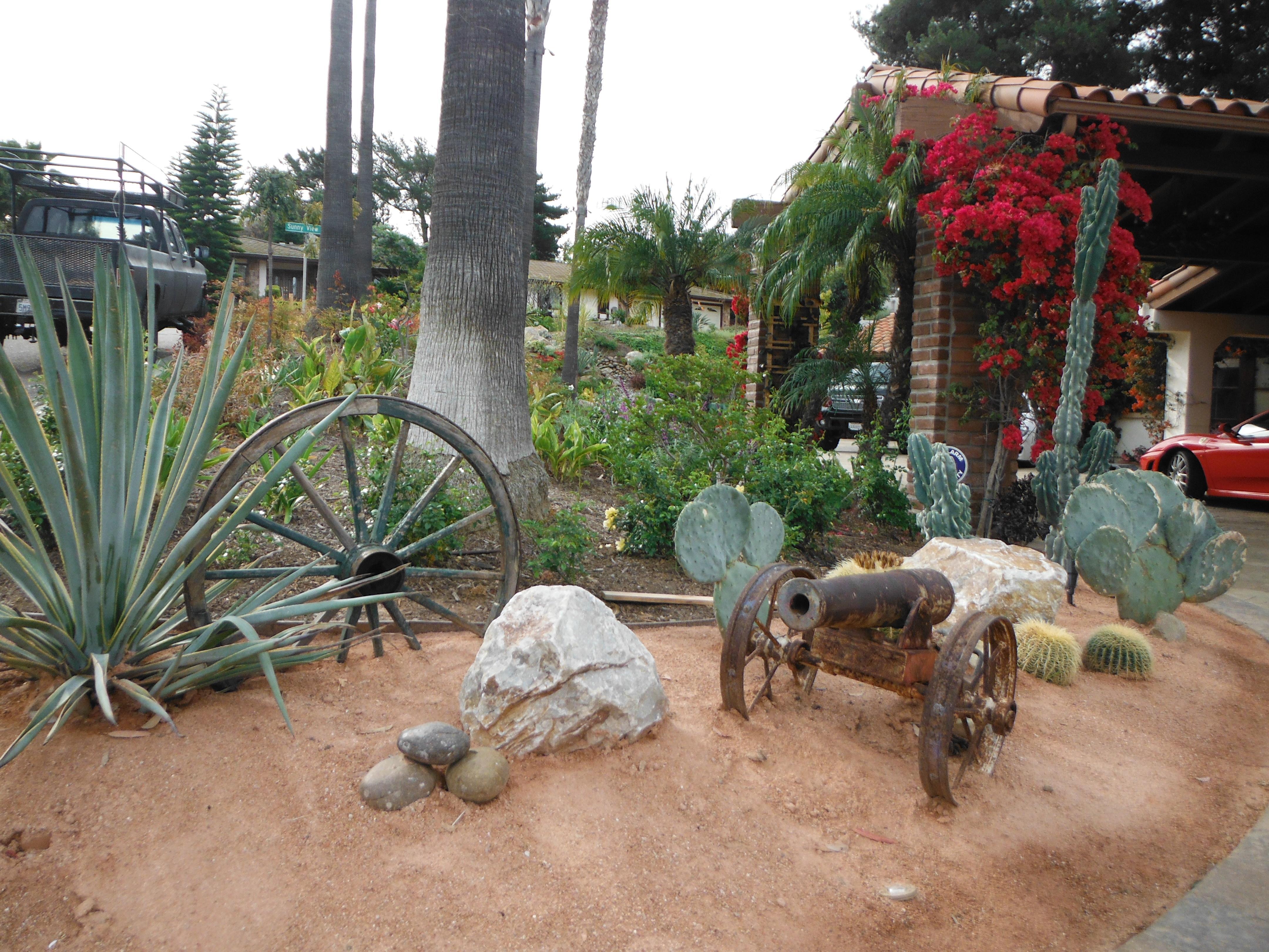 Large Boulders were craned in to complement the cacti. We found the old wagon wheel and added it to round out the southwest feel. 