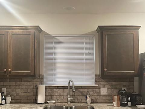 We love how our Mini Blinds fit this snug little window above the kitchen sink perfectly in this house in Claremore. With our Blinds, you can easily move about in the kitchen without being bothered by harsh sunlight.