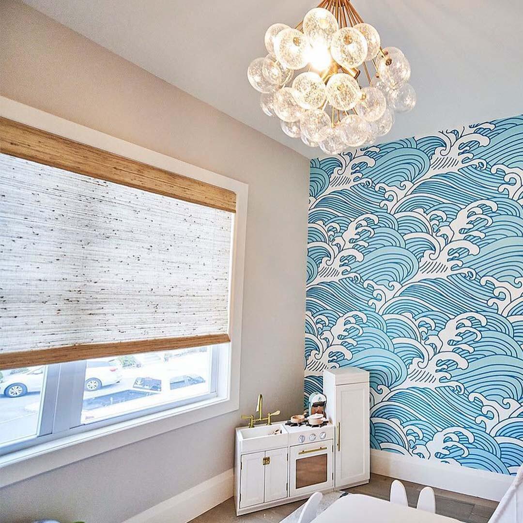 @waterfrontfarmhouse has us dreaming of warmer summer months in this beachy playroom with the addition of woven wood shades from Budget Blinds.