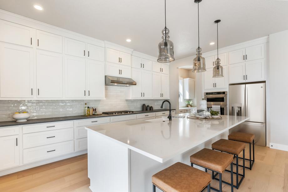 Well-designed kitchen with double-stacked kitchen cabinets provides plenty of storage