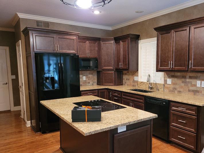 This Leawood home needed a makeover-and something to match the wall tone and backsplash. We created these Brown Cabinets as the perfect match!