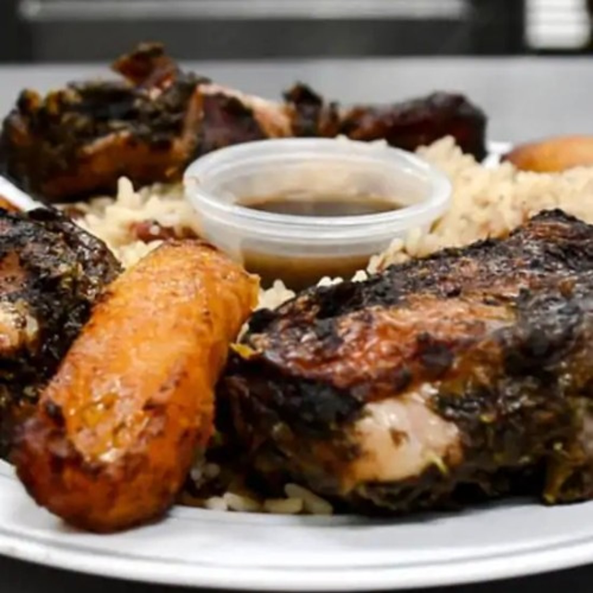 2- Jerk Chicken Served with Jasmine Rice Cabbage and Plantains