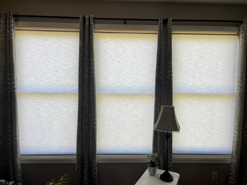 Here's an elegant look! In this Westonka home, our Roller Shades are looking great between pairs of matching narrow drapes! You can do something similar if you have lots of windows!