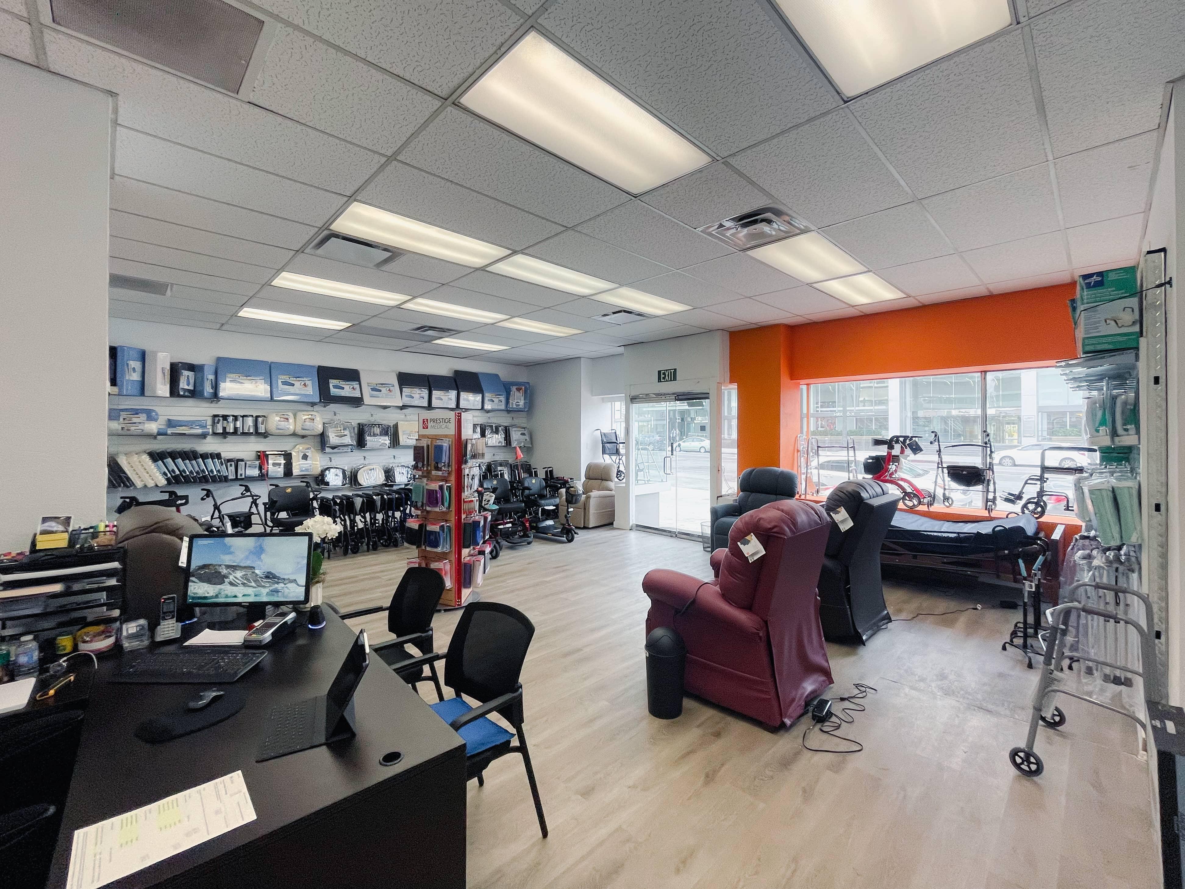 Interior view of our medical equipment and supply store, on the floor you see walkers, wheelchairs, and massage chairs.
