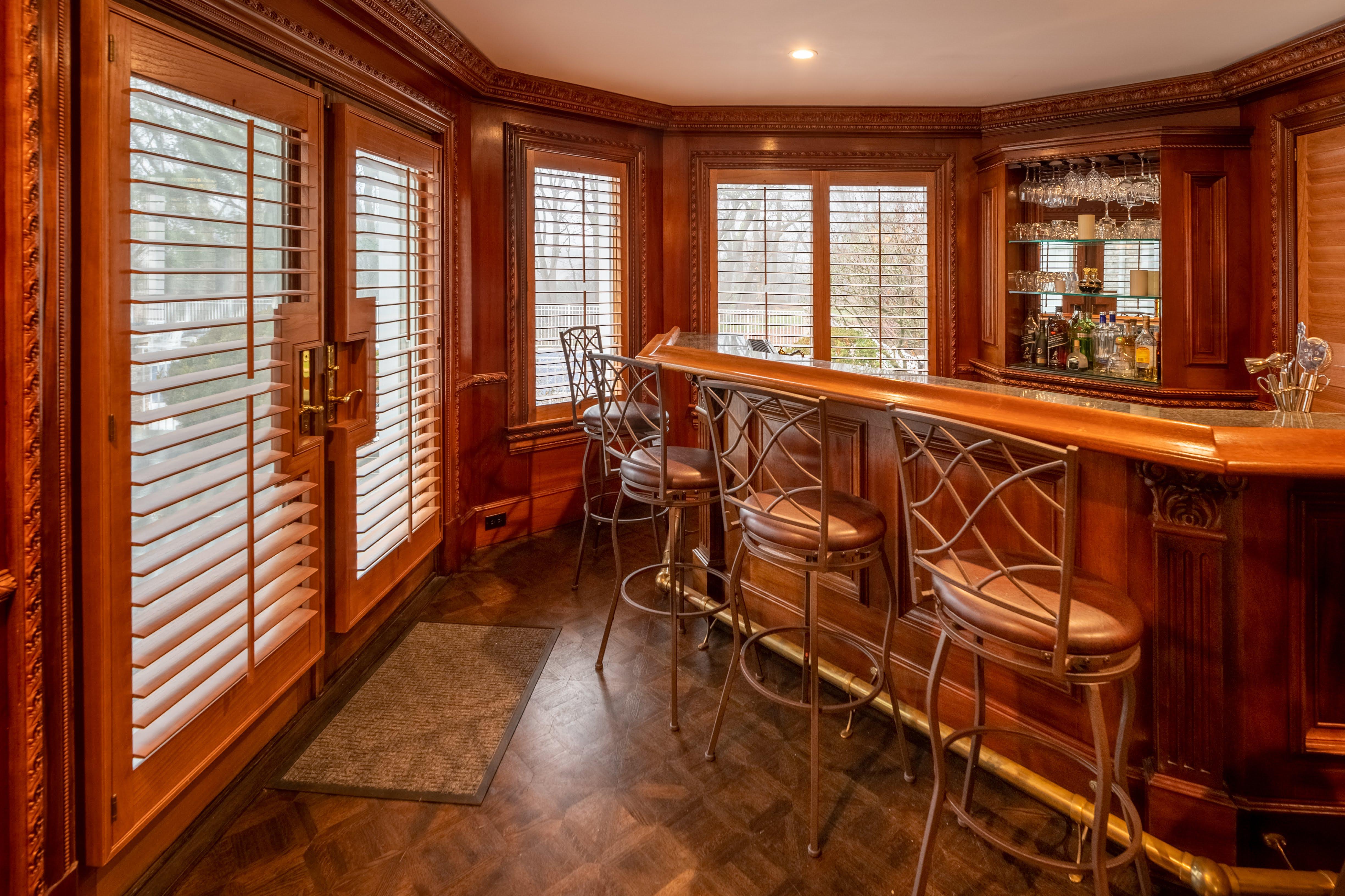 Wood floors, wood bar and custom wood shutters to complete this gorgeous bar in Colts Neck, NJ