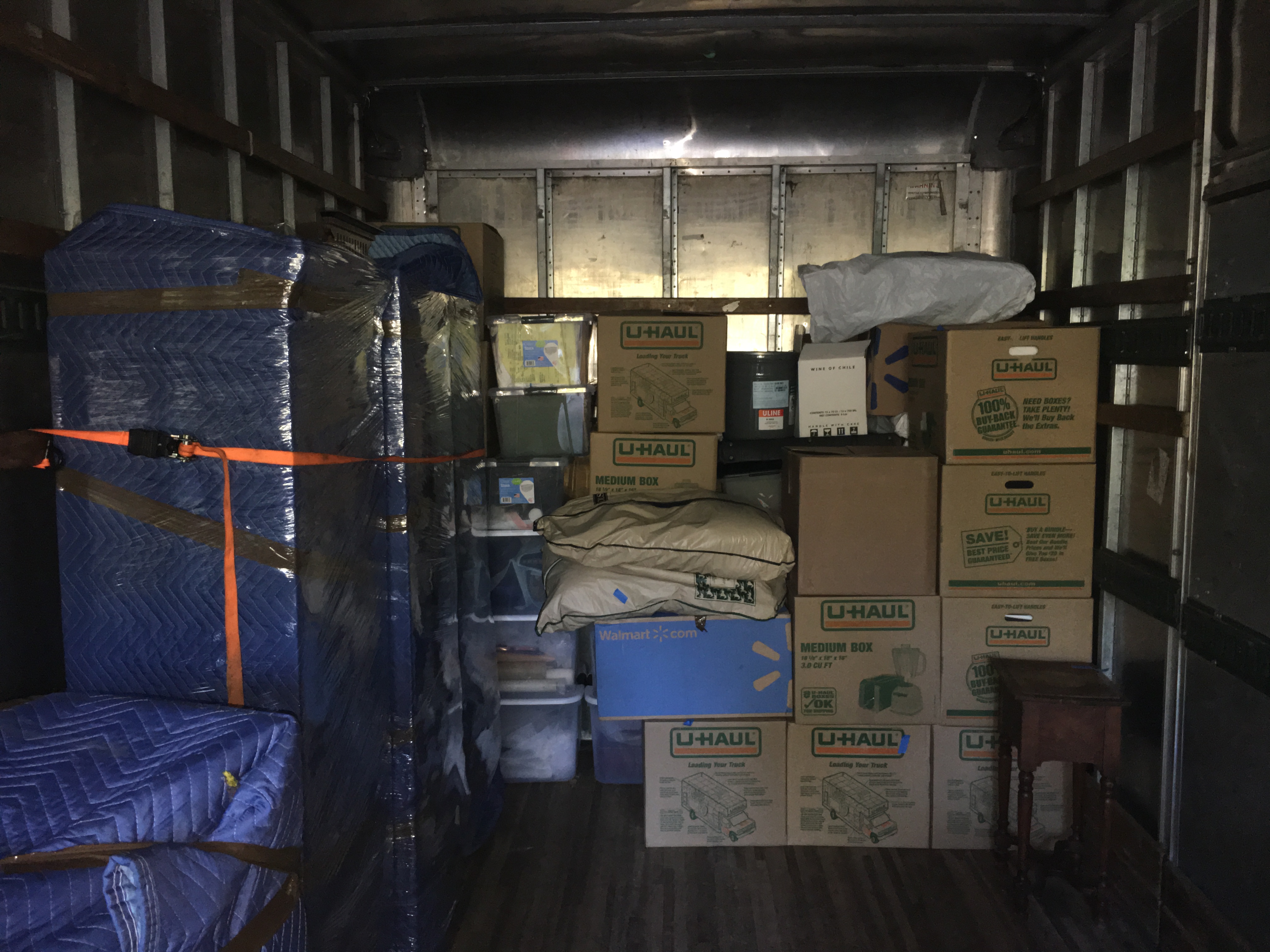 Boxes and furniture stocked in truck during move.