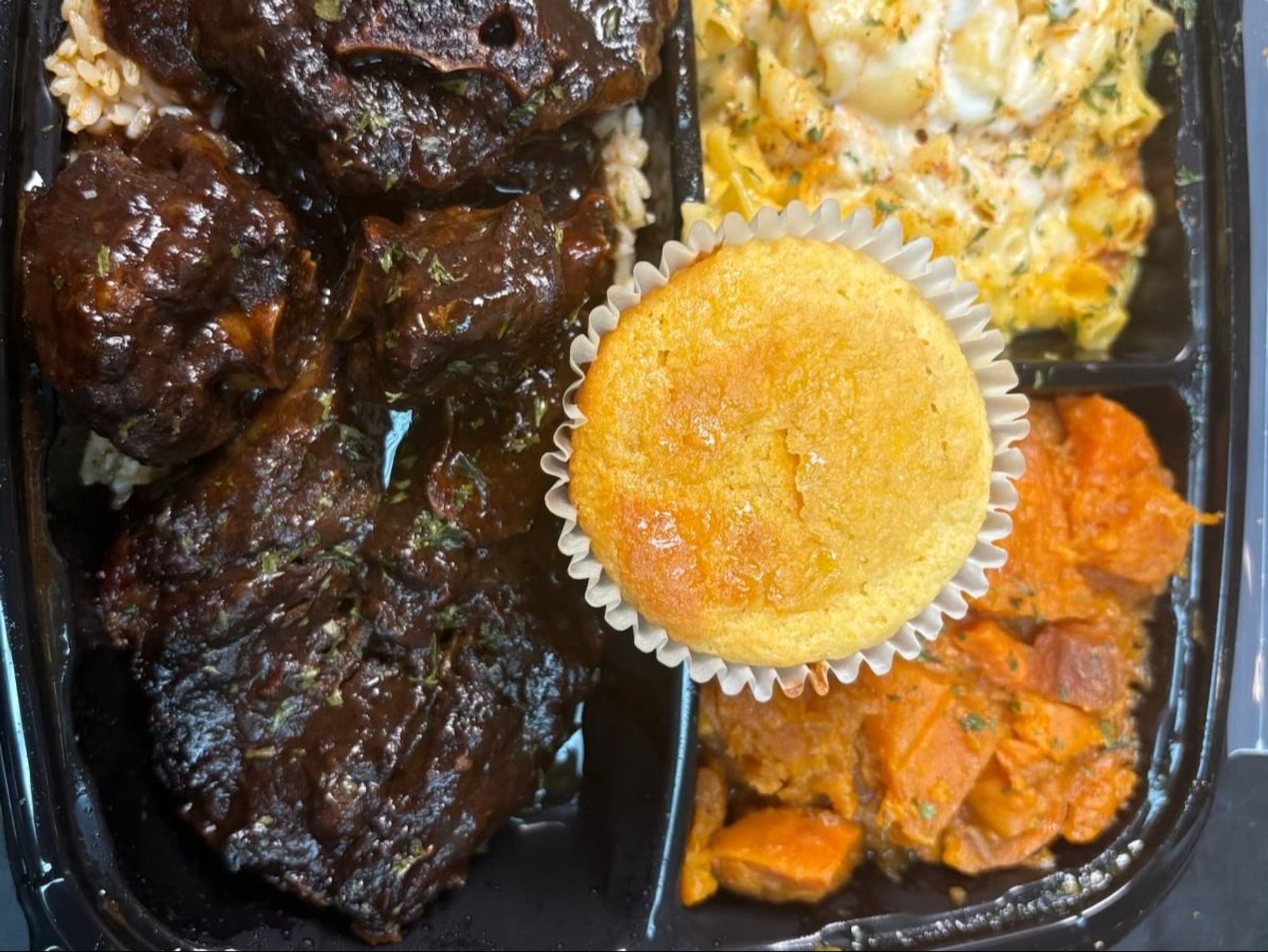 Oxtail Plate Served with Yams Mac N' Cheese and Cornbread
