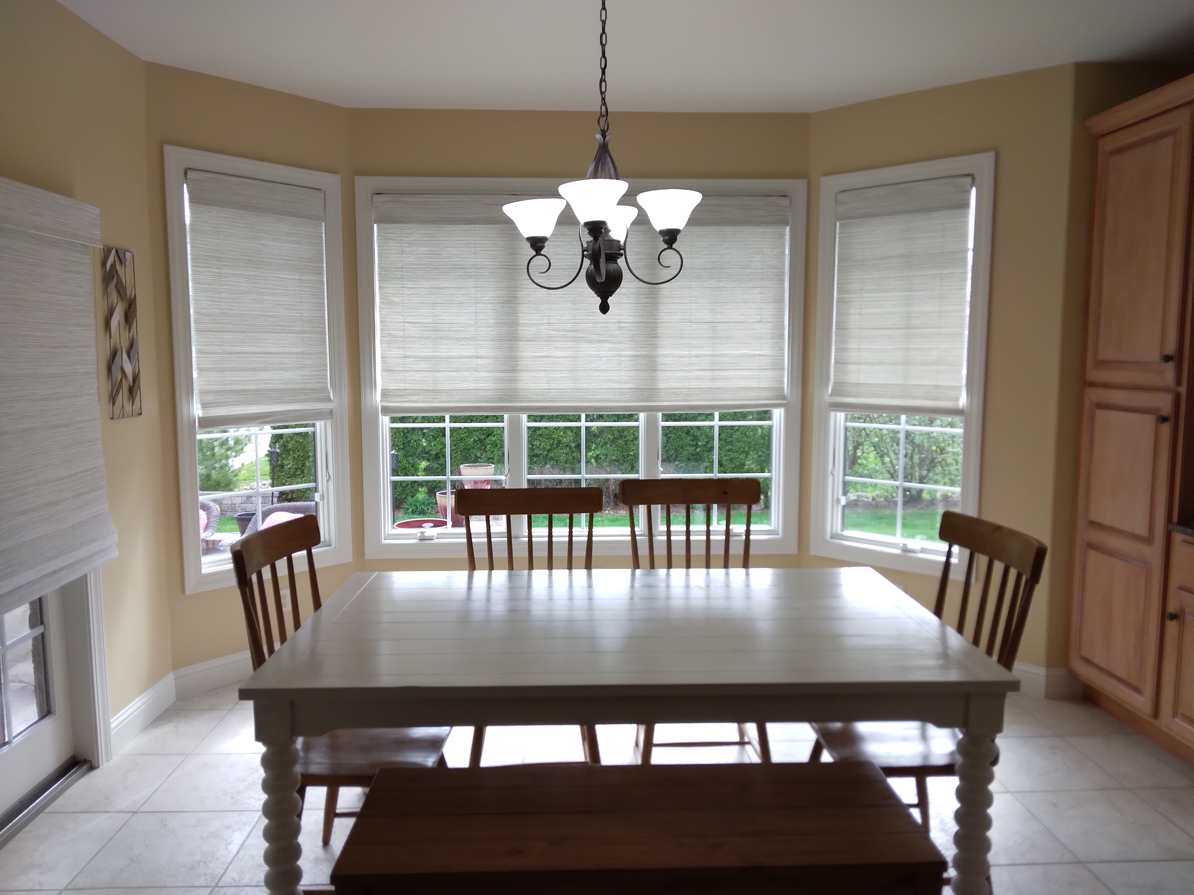 These natural shades in this Springfield Illinois dining room add a lot of style while blending in with the view of the backyard.  BudgetBlinds  WindowCoverings  Shades  NaturalShades  SpringfieldIllinois