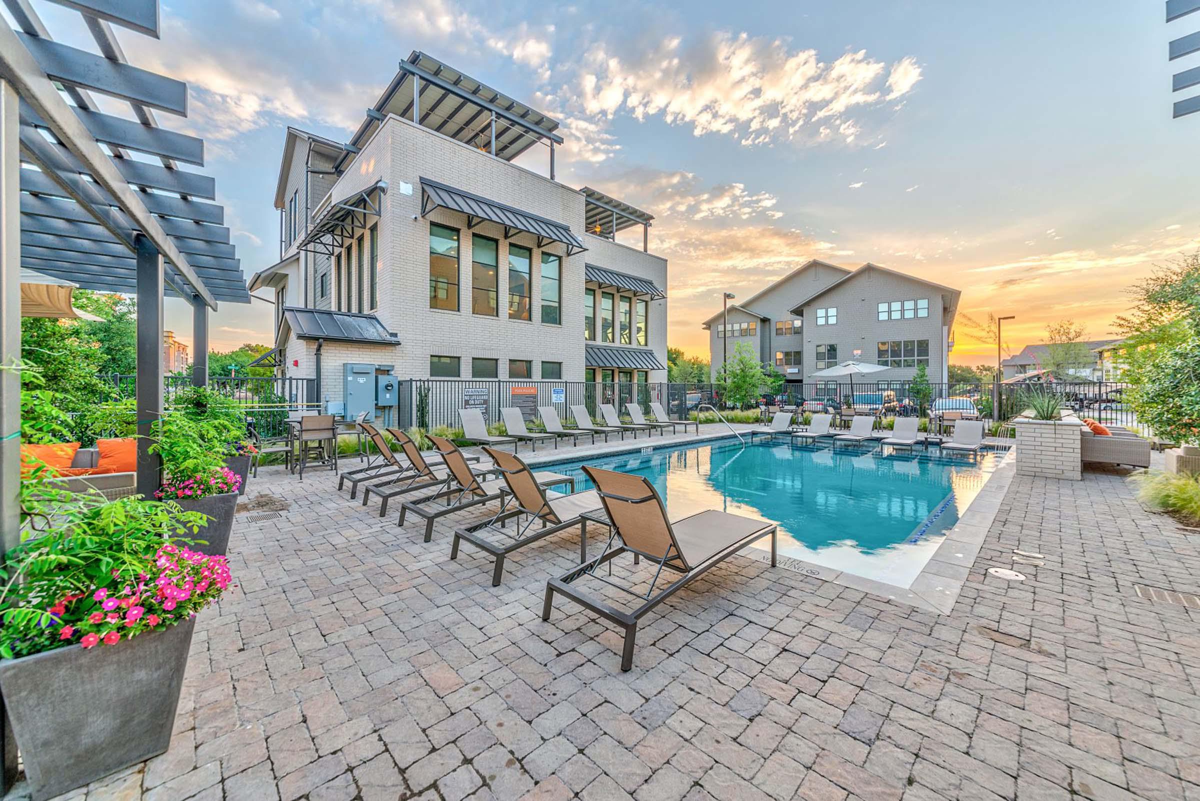 Villas side pool and amenities building at twilight