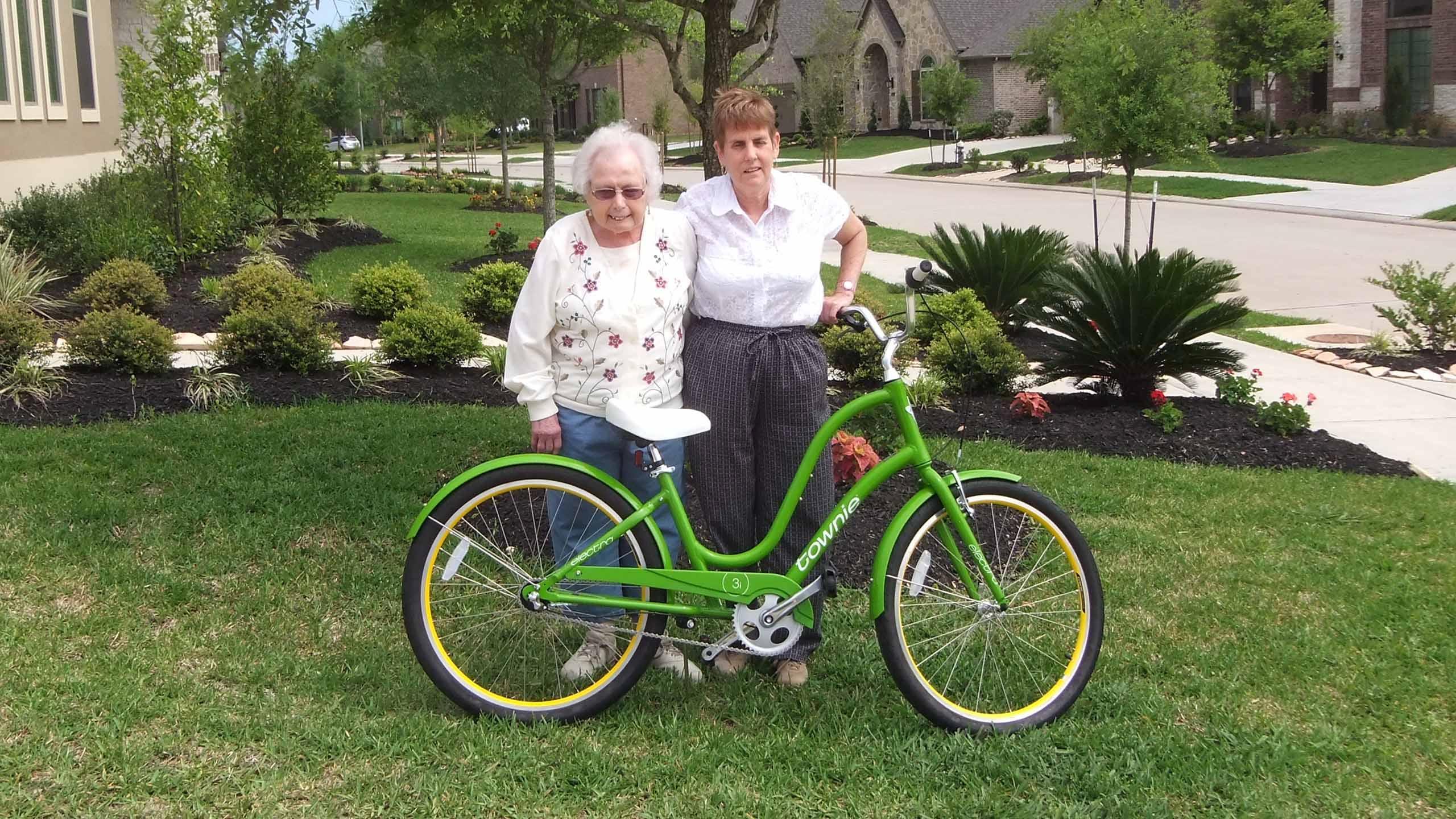 A happy customer in front of their new home. They also bought a new bike from Terri Gill at Sugar Cycles.