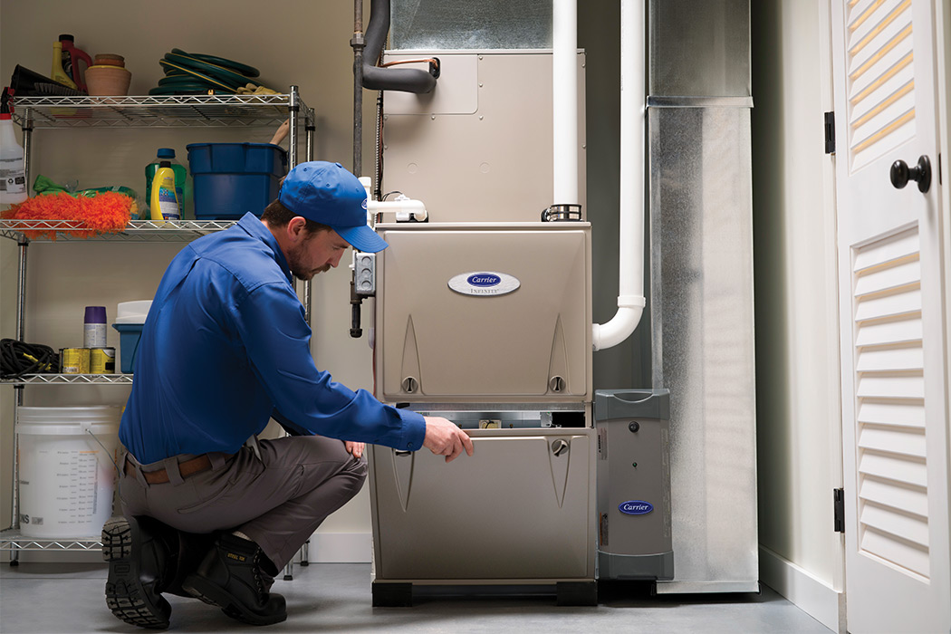 A Carrier dealer discusses air conditioner repair and service with a homeowner