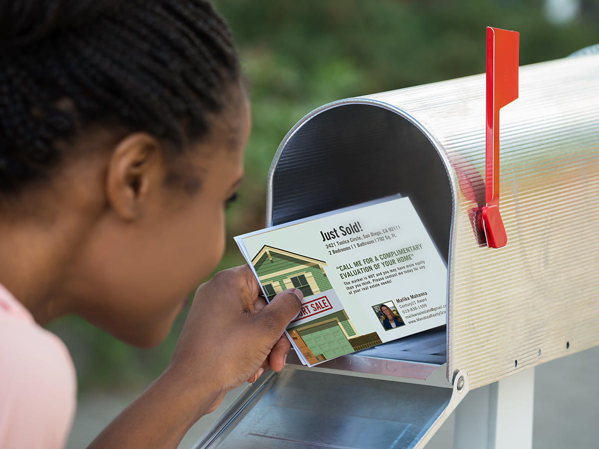 woman removing direct mail from mailbox