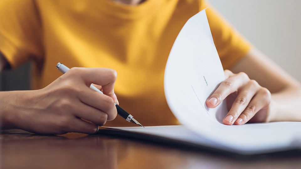 a woman filling out some customs documents