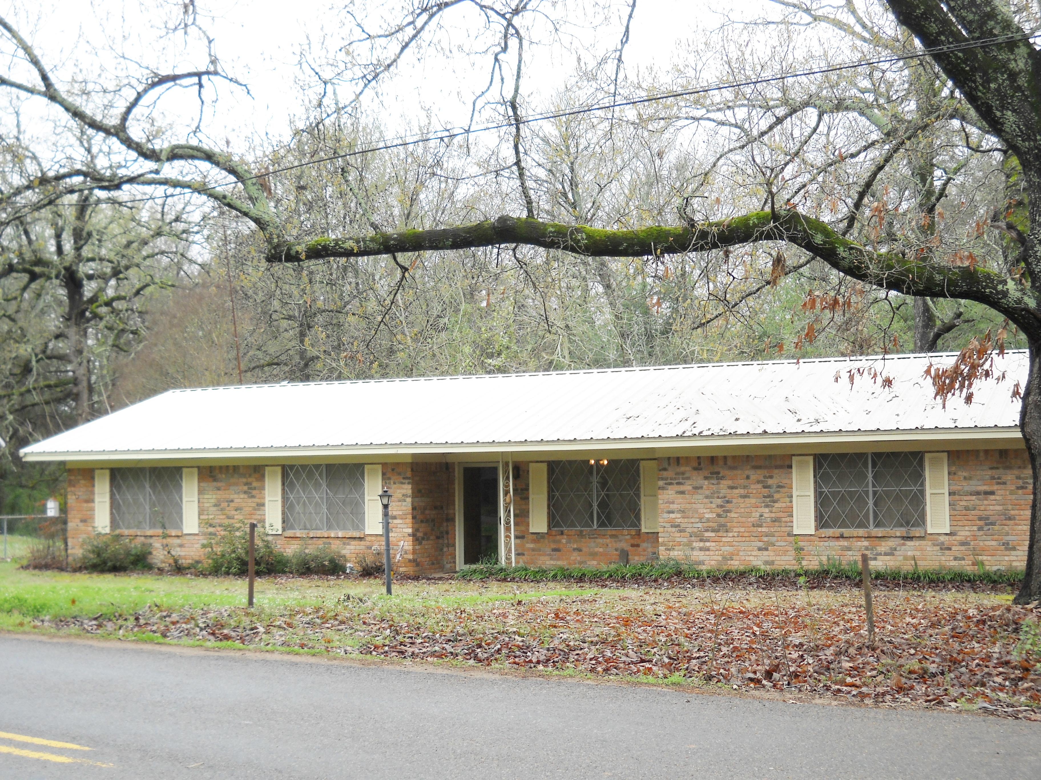 Home in great school district with lots of potential. Brick home with 3 bedrooms and one and a half bathrooms on large corner lot, fenced backyard, covered patio and steel construction RV parking pad on slab.