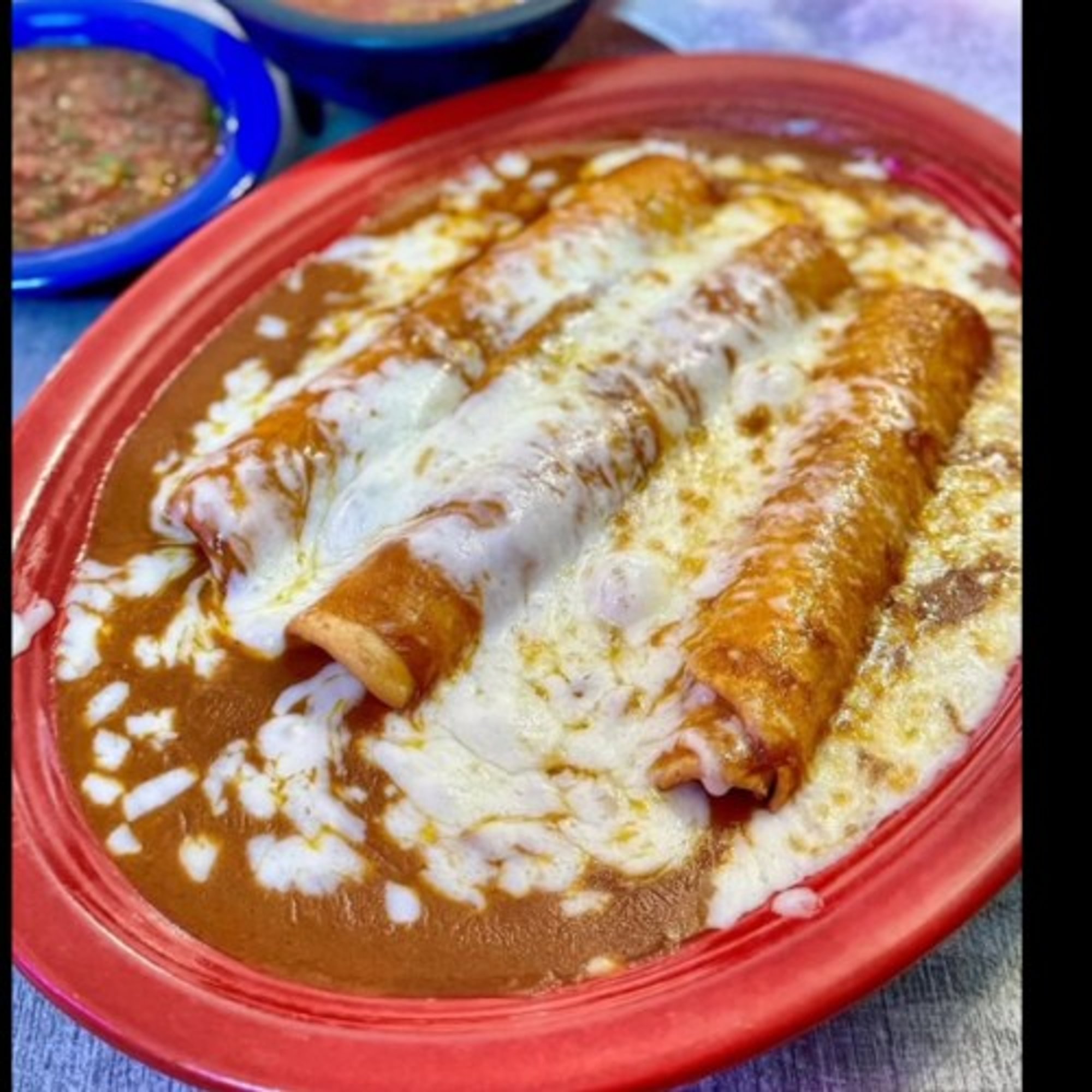 Three Sonoran Rolled Tacos Enchilada Style