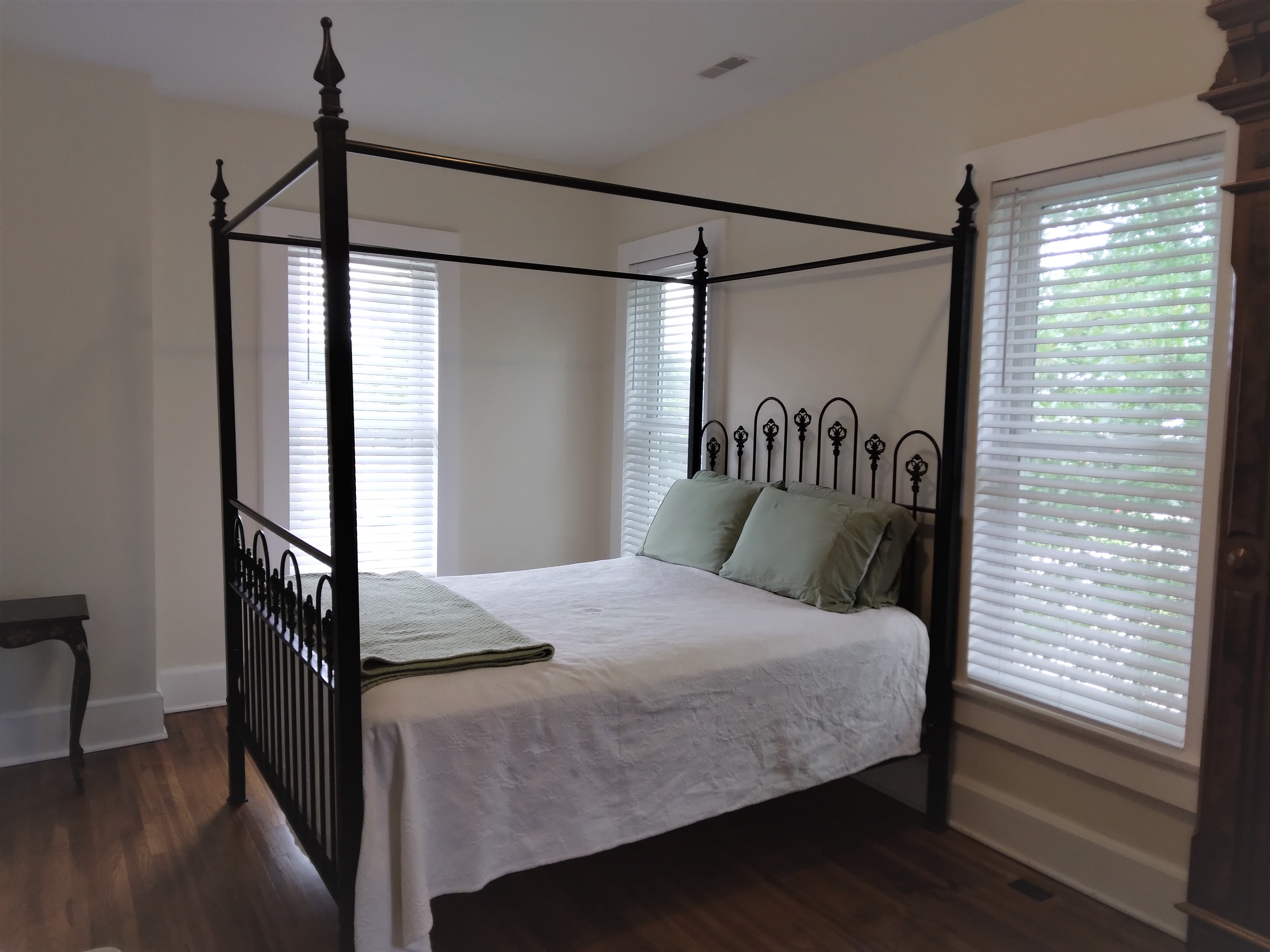 White cordless faux-wood blinds in Springfield Illinois bedroom.  BudgetBlinds  Window Coverings  Blinds  SpringfieldIllinois