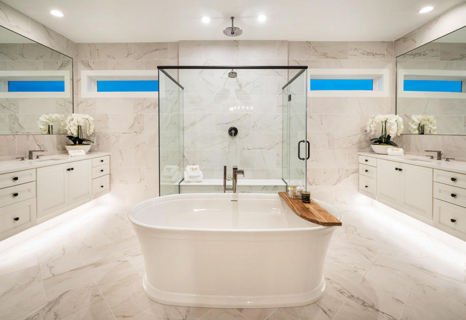 Spa-like primary bath with dual vanities and glass-enclosed shower