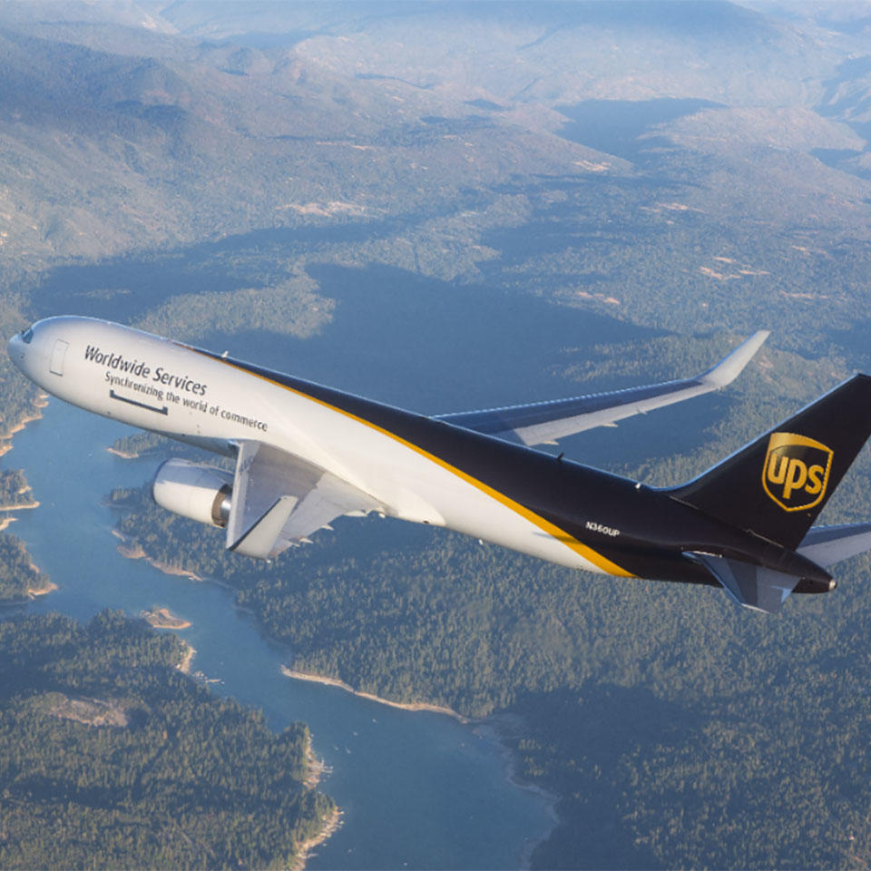 UPS delivery plane flying high above a river