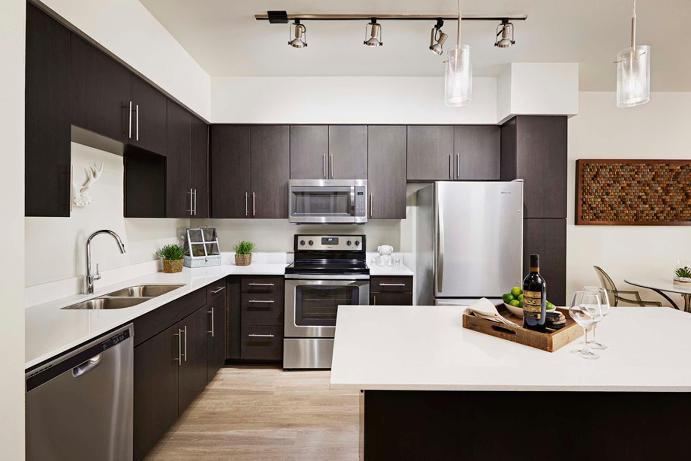 Modern style kitchen with quartz countertops and stainless steel appliances