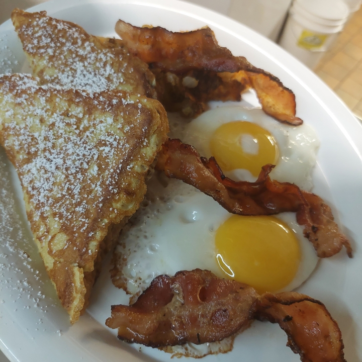 C. Two Large Eggs, Two Triangles Challah French Toast, Home Fries and Bacon or Sausage