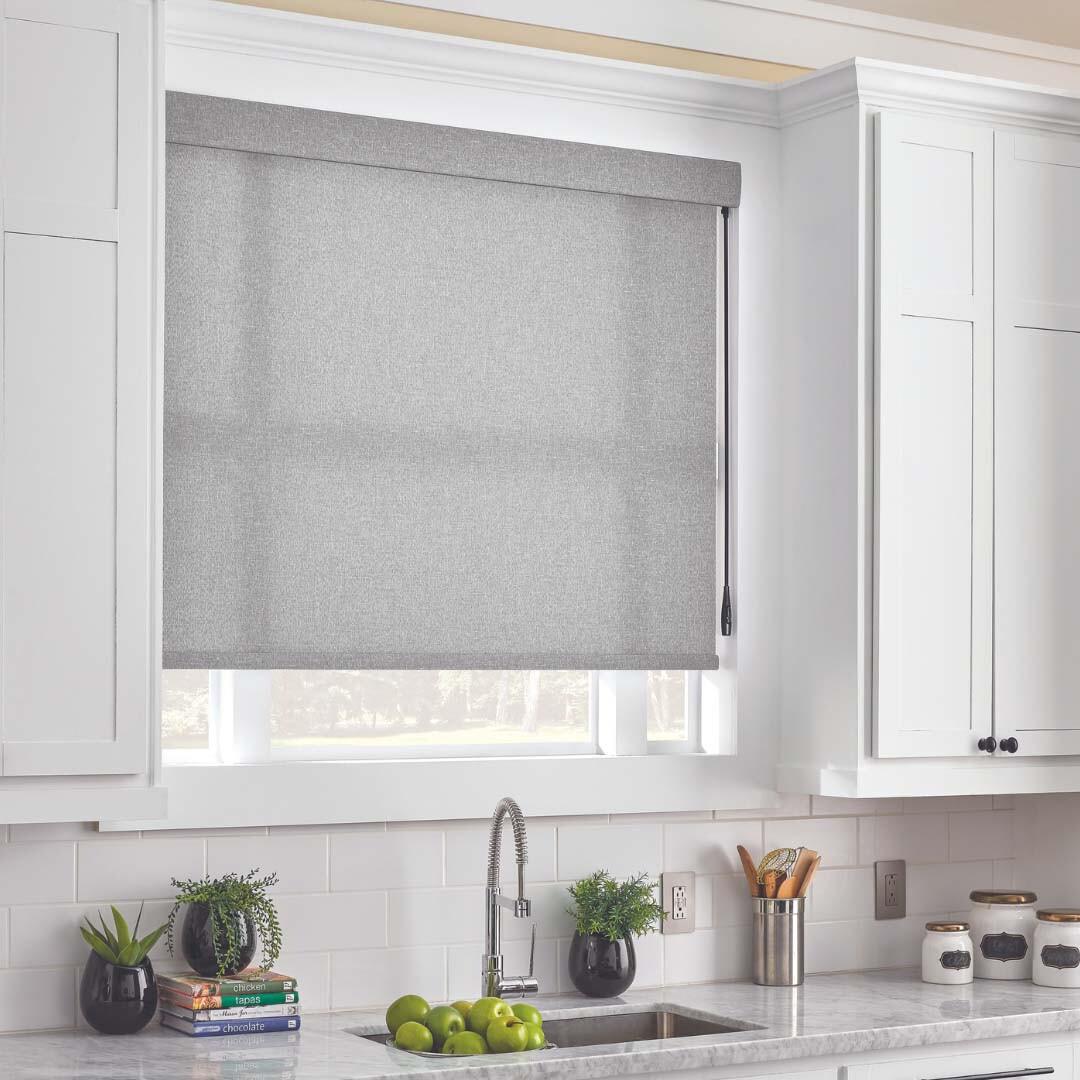 Light filtering roller shade with motorized wand over a kitchen sink