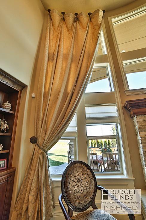 Tieback hardware provides a dramatic look with these Draperies installed in Meridian, ID. The high windows make these Drapes the statement for the room.  BudgetBlindsBoise  CustomDraperies  DrapedInBeauty  FreeConsultation  WindowWednesday